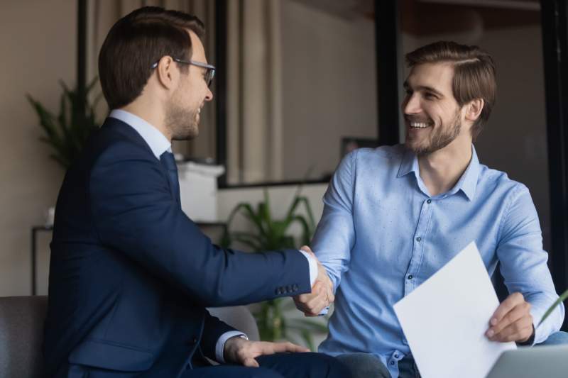 A businessman shakes hands with a commercial conveyancing solicitor