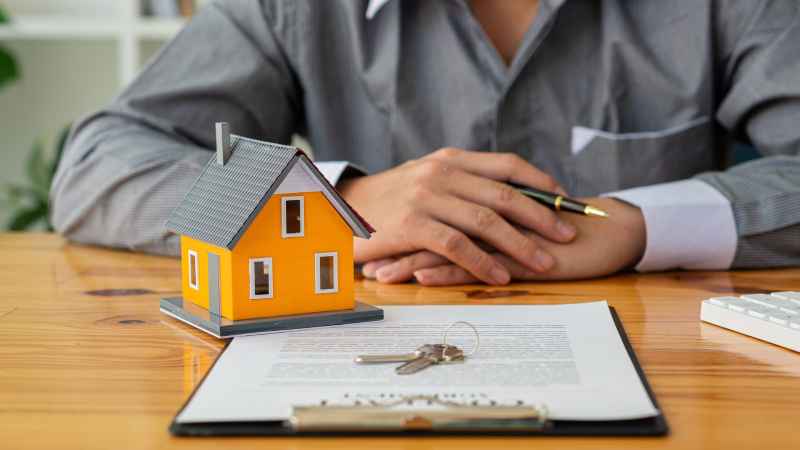 A man signs a contract to purchase a new build property