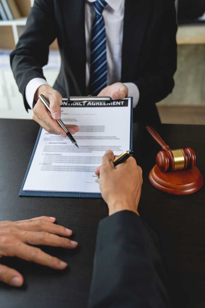 A man signs a dispute resolution agreement